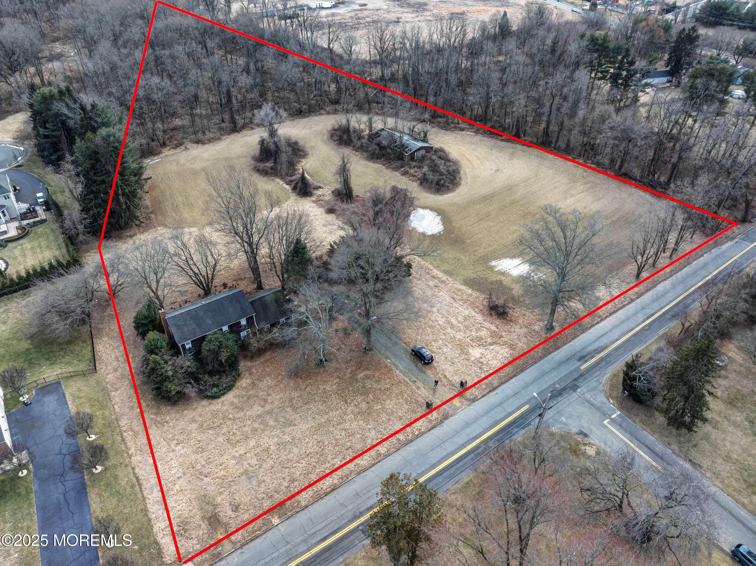 16 Pleasant Valley Road Morganville, NJ 07751 - Photo 16 of 18 a view of a backyard with wooden fence