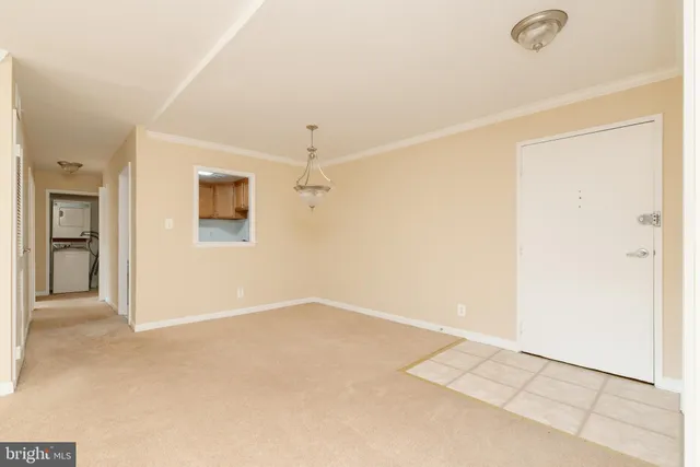an empty room with a ceiling fan and a window