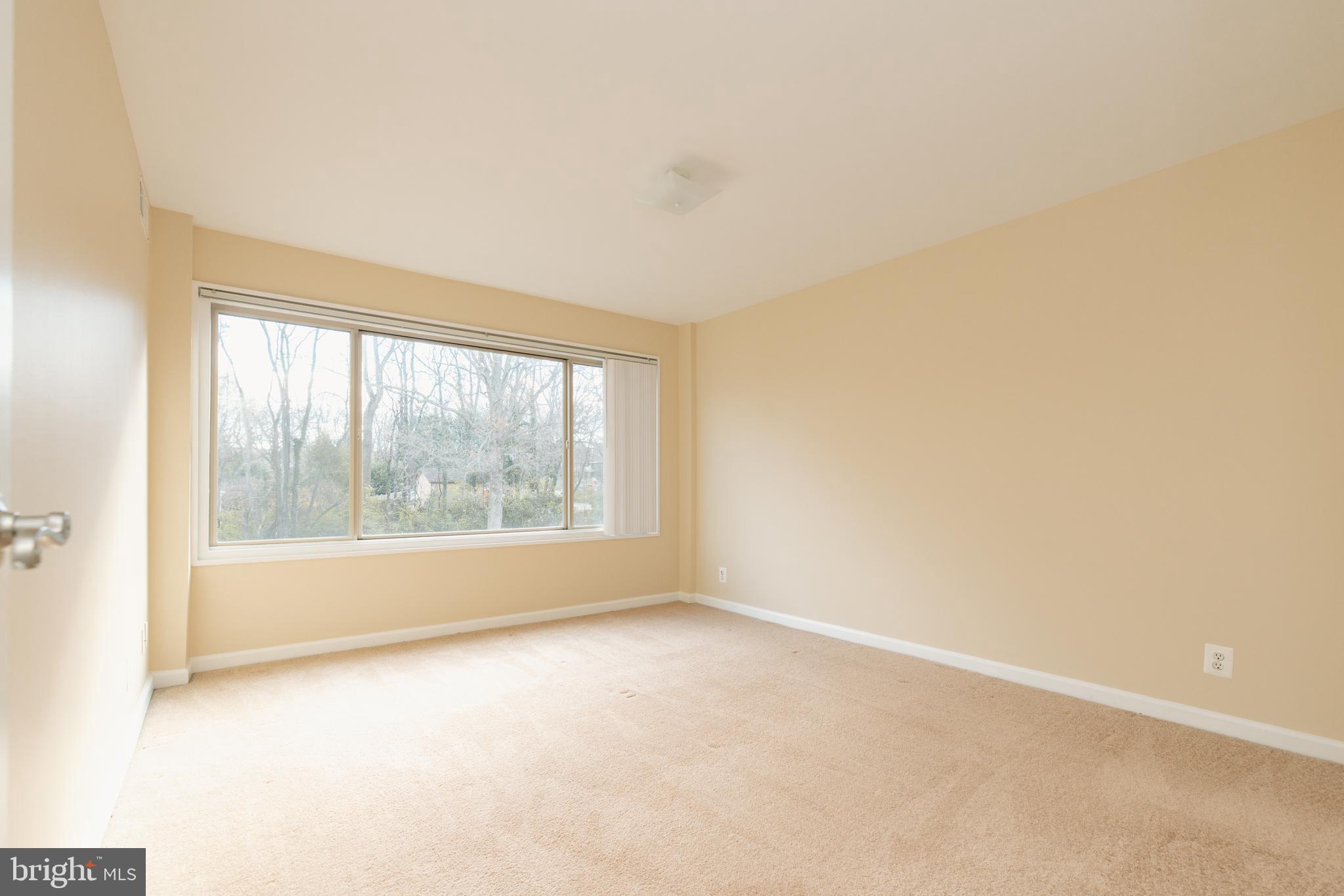 10570 Main Street, Unit 424 Fairfax, VA 22030 - Photo 9 of 18 an empty room with an outdoor view and a window