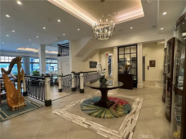a lobby with furniture and a chandelier