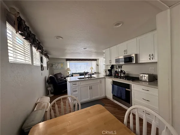 a kitchen with sink cabinets and stove top oven