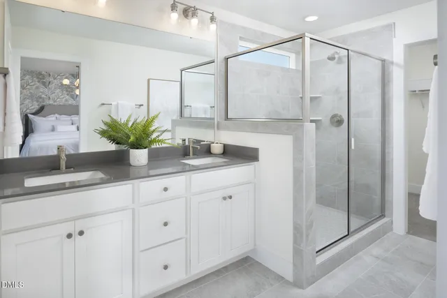 a bathroom with a shower sink and mirror