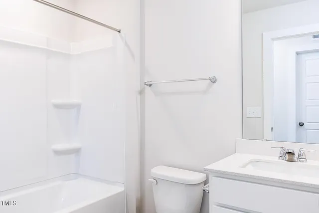 a view of house with swimming pool and front yard