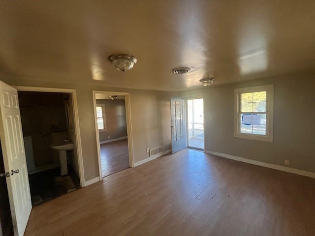 2025 East Pythian Avenue Decatur, IL 62526 - Photo 3 of 15 an empty room with wooden floor and windows