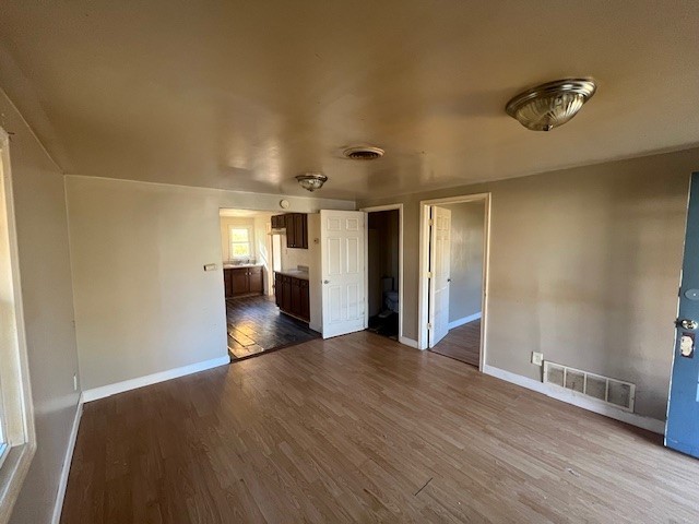 2025 East Pythian Avenue Decatur, IL 62526 - Photo 4 of 15 a view of an empty room with wooden floor and a window