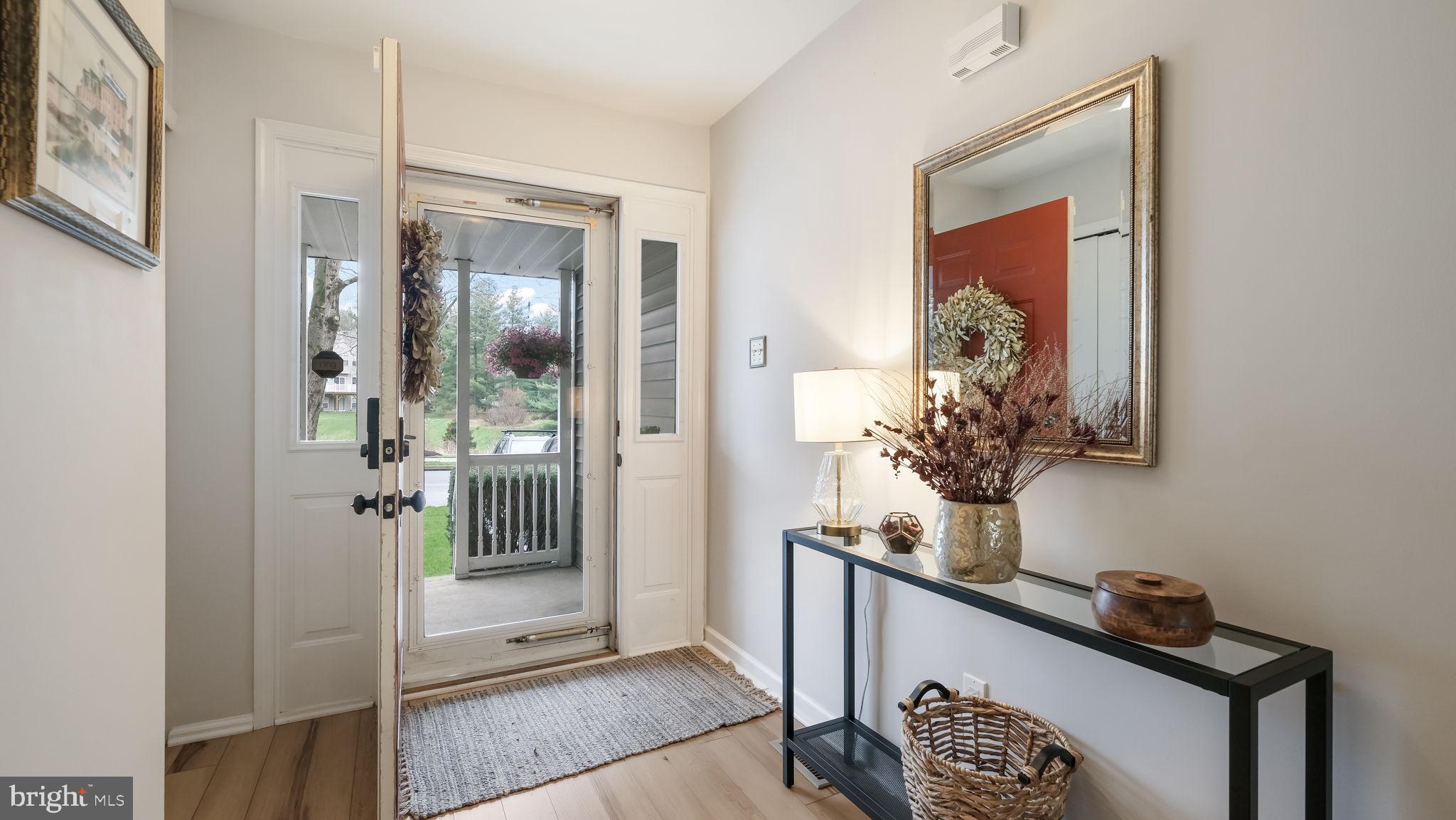 84 Trafalgar Road Doylestown, PA 18901 - Photo 8 of 50 a view of a hallway with a potted plant on a table and a mirror