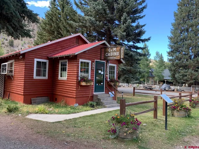 a front view of a house with a garden and sitting area