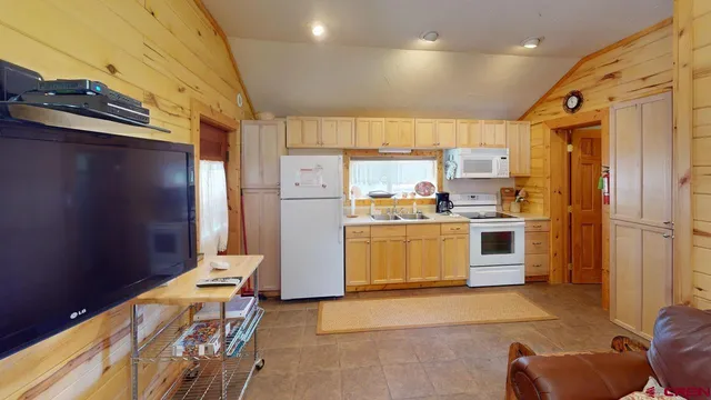 a kitchen with a refrigerator a stove and a cabinets