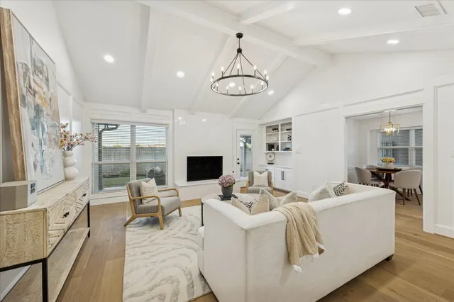 a living room with furniture flat screen tv and wooden floor