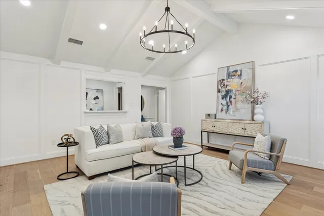 a living room with furniture and a chandelier