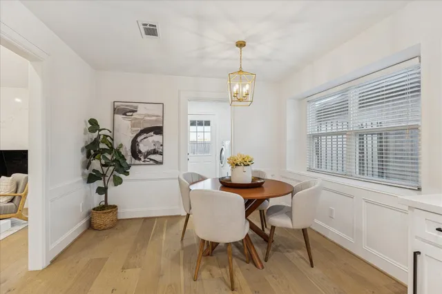 a view of a dining room with furniture wooden floor and chandelier