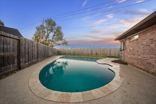 a view of a swimming pool with a seating area
