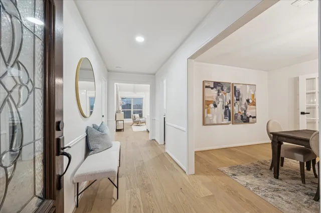 a living room with furniture a mirror and a painting on the wall