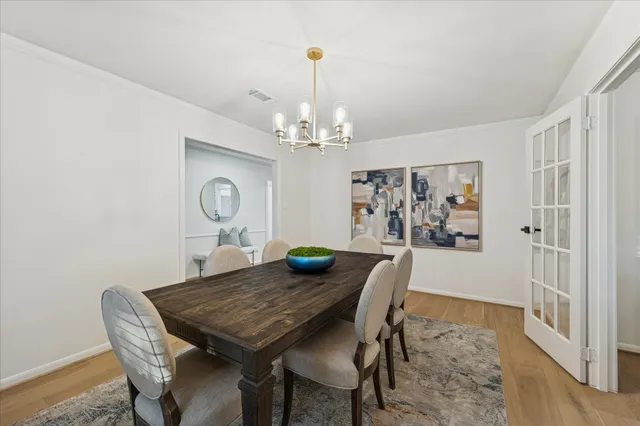 a view of a dining room with furniture and chandelier