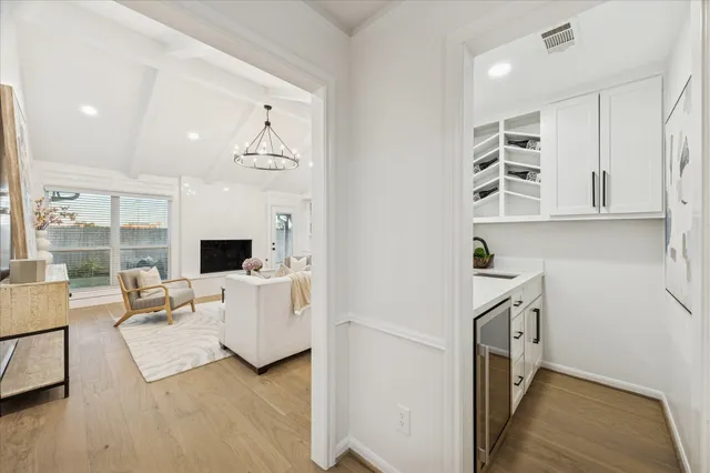 a living room with furniture a flat screen tv and next to a window