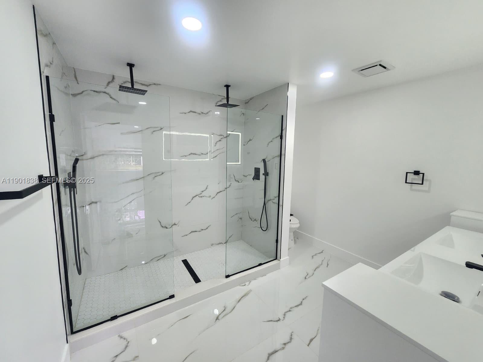 19621 Southwest 308th Street Homestead, FL 33030 - Photo 19 of 31 a bathroom with a shower and a sink