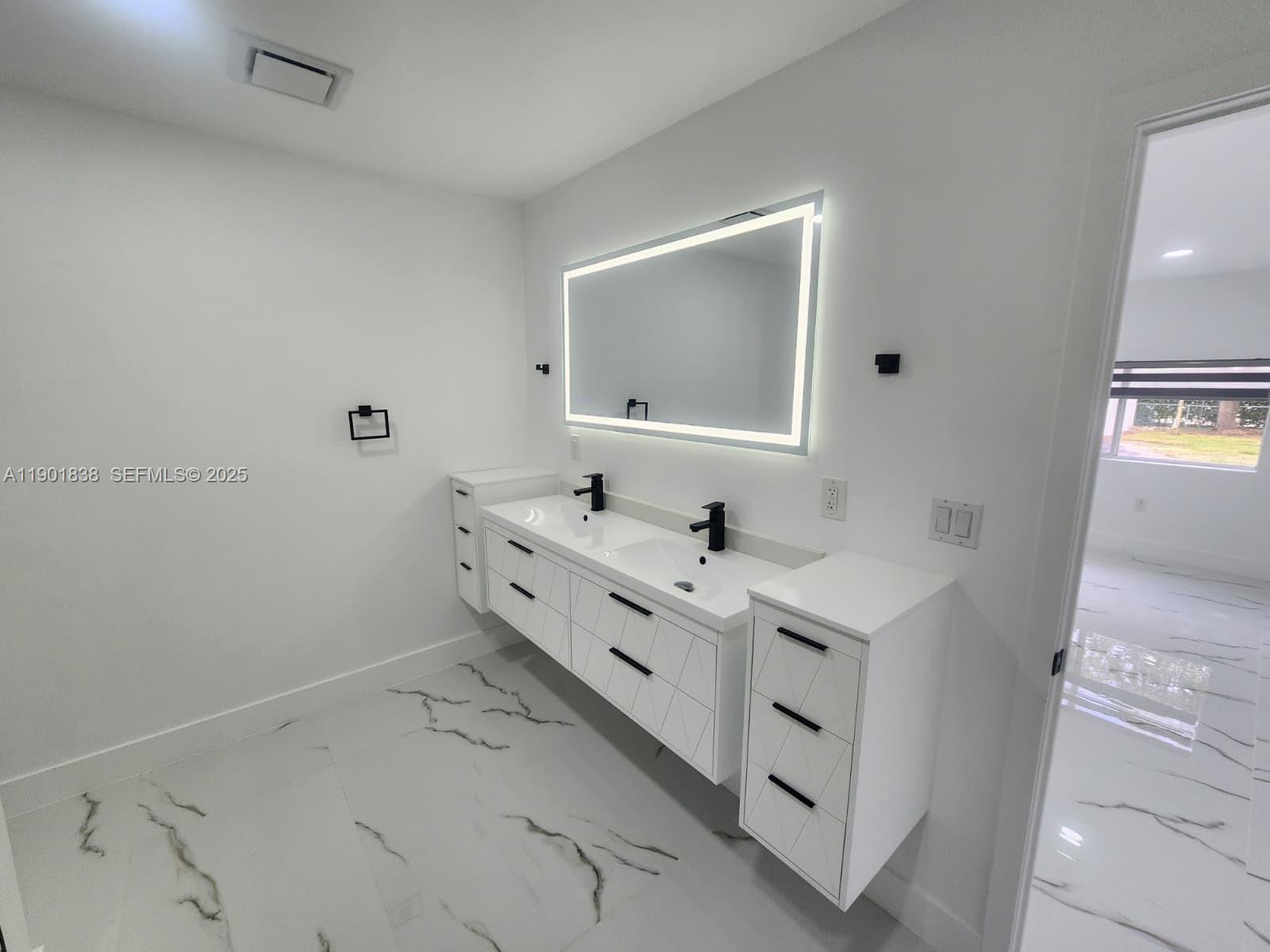 19621 Southwest 308th Street Homestead, FL 33030 - Photo 20 of 31 a bathroom with a double vanity sink and mirror