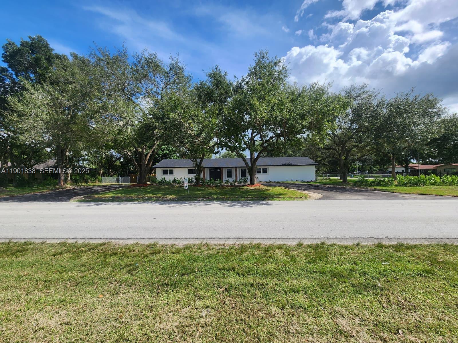 19621 Southwest 308th Street Homestead, FL 33030 - Photo 2 of 31 a swimming pool with outdoor seating and yard