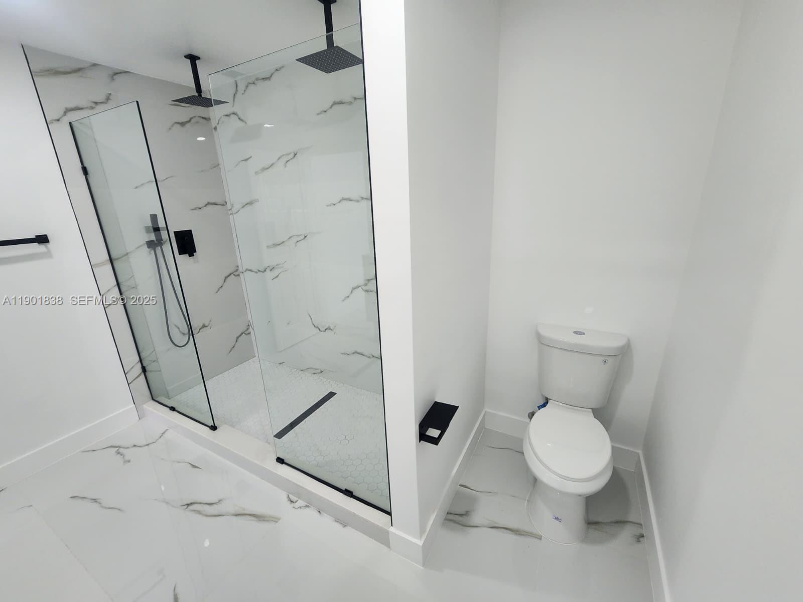 19621 Southwest 308th Street Homestead, FL 33030 - Photo 21 of 31 a white toilet sitting next to a shower