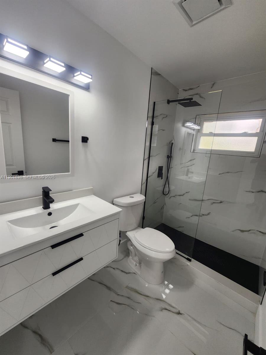 19621 Southwest 308th Street Homestead, FL 33030 - Photo 24 of 31 a bathroom with a sink toilet and shower