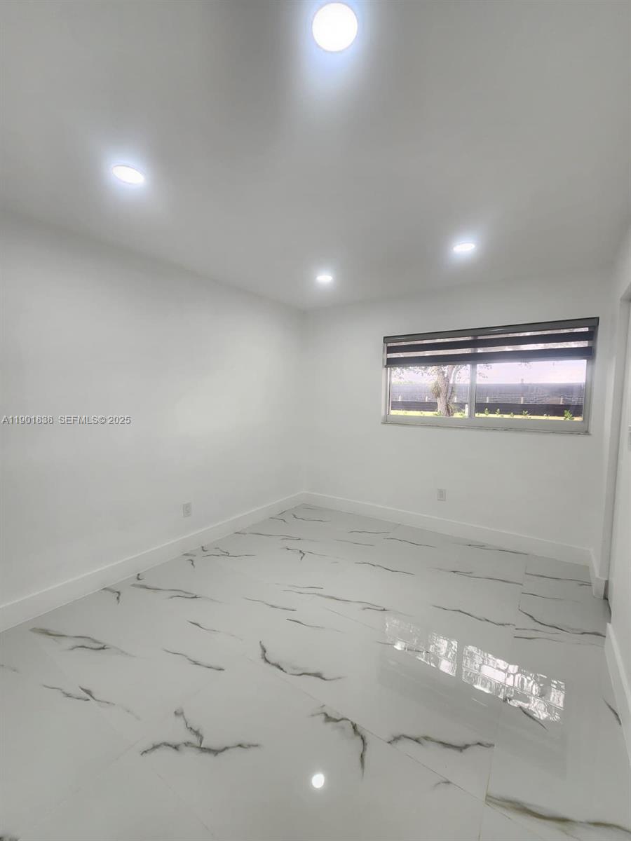 19621 Southwest 308th Street Homestead, FL 33030 - Photo 27 of 31 an empty room with a space