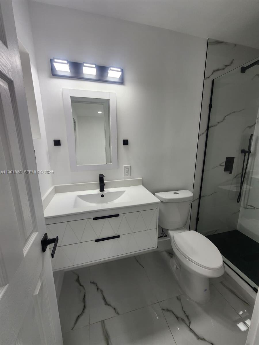 19621 Southwest 308th Street Homestead, FL 33030 - Photo 30 of 31 a bathroom with a sink toilet and shower