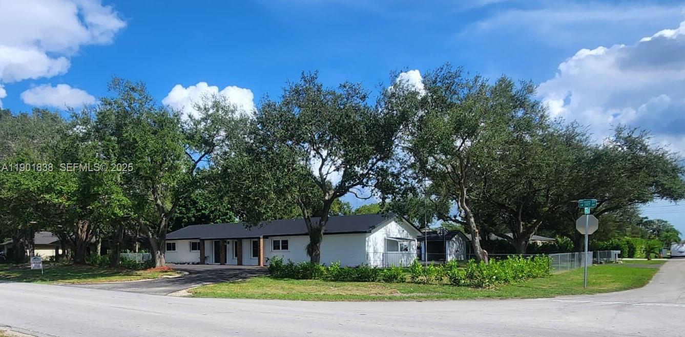 19621 Southwest 308th Street Homestead, FL 33030 - Photo 3 of 31 a front view of a house with a yard and garage