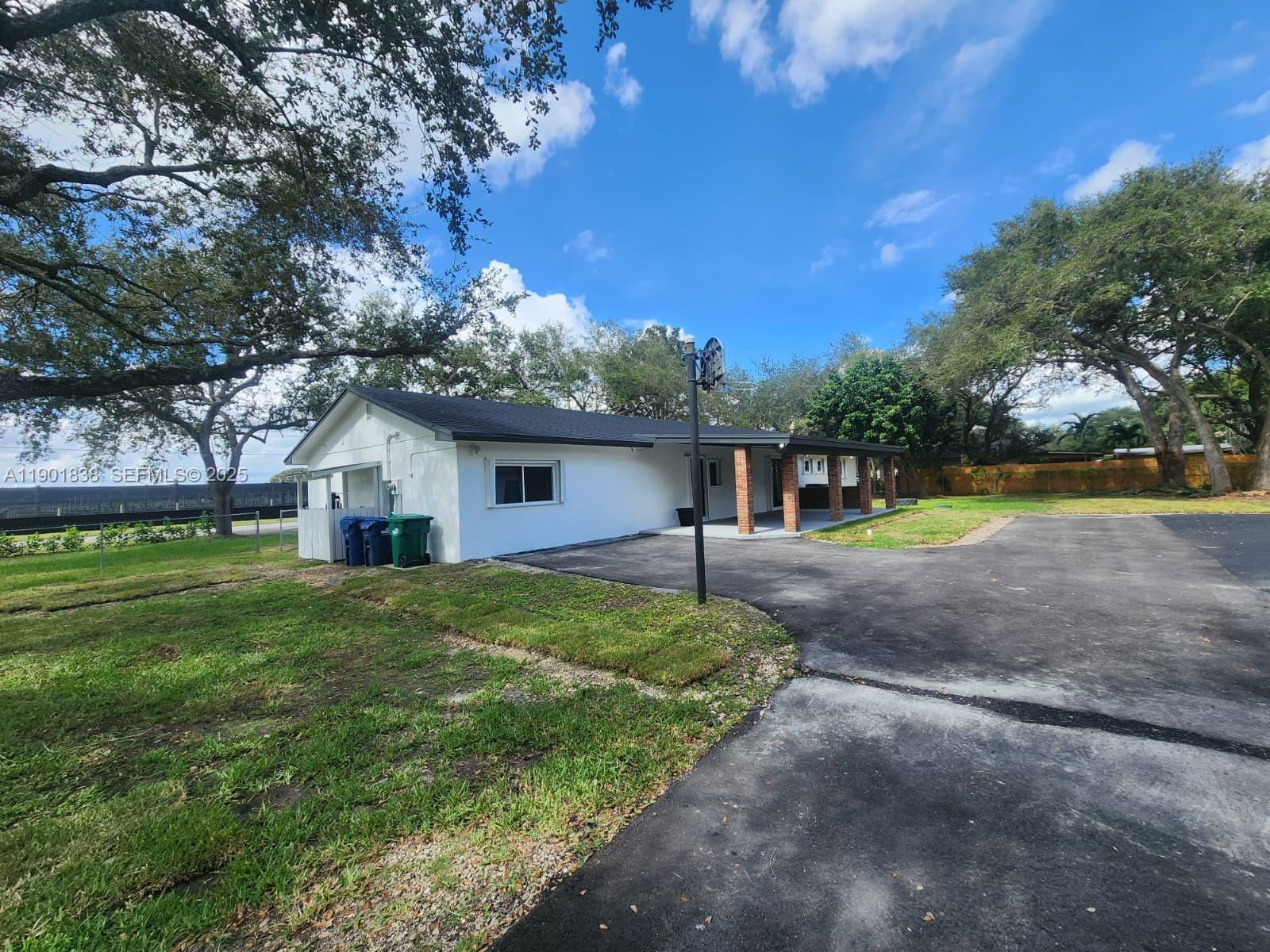 19621 Southwest 308th Street Homestead, FL 33030 - Photo 5 of 31 a house with huge green field in front of it