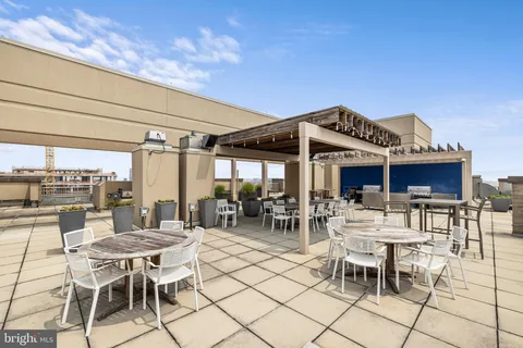 a view of a patio with dining table and chairs