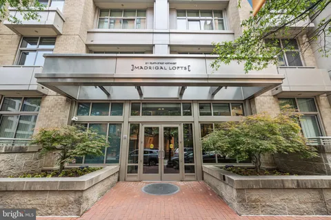 a city street lined with buildings and trees