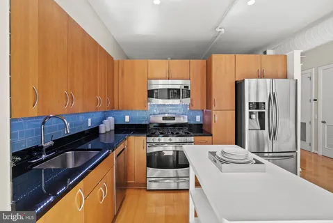 a kitchen with a refrigerator sink and stove