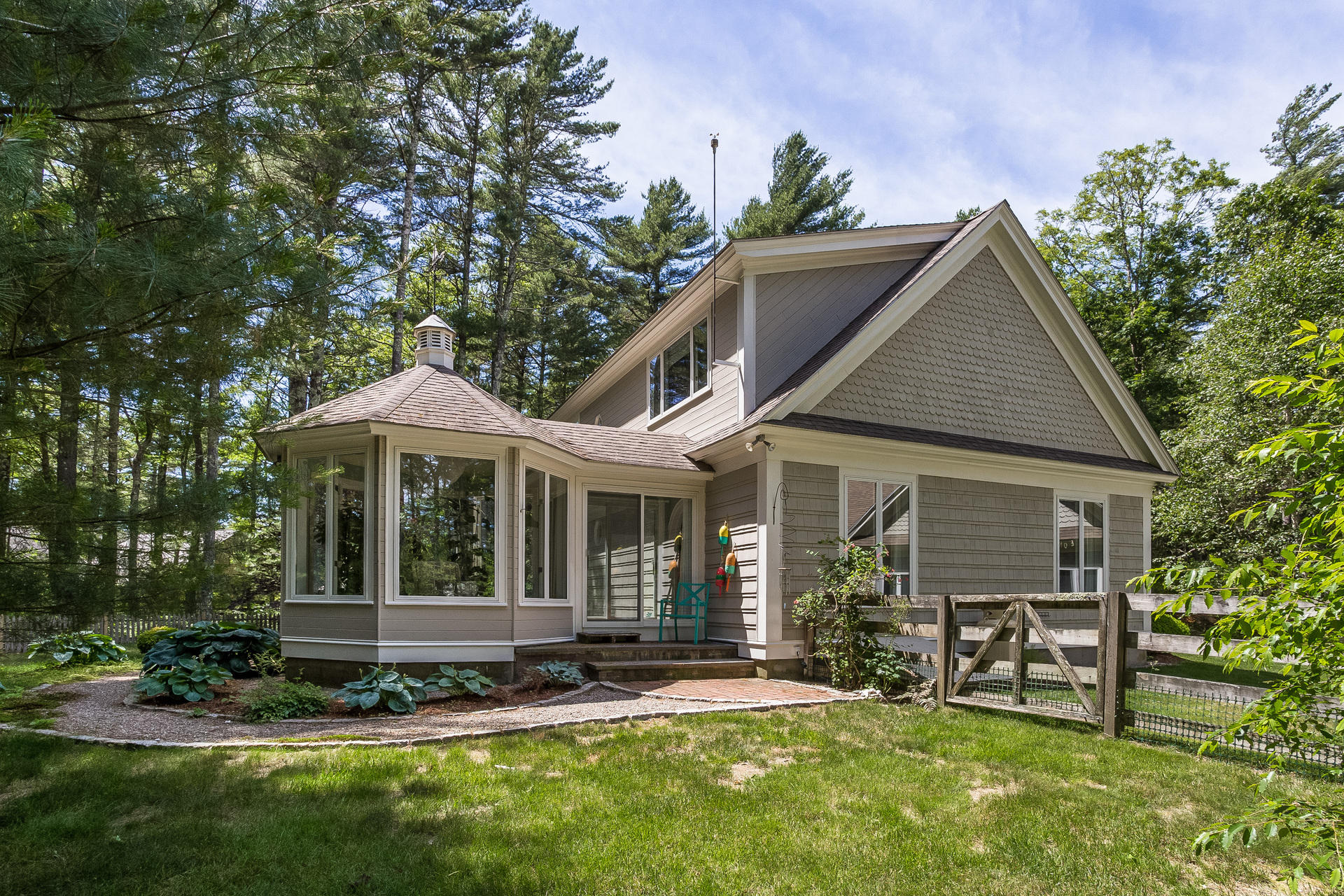 584 Delano Road Marion, MA 02738 - Photo 20 of 24 a front view of a house with a garden and plants