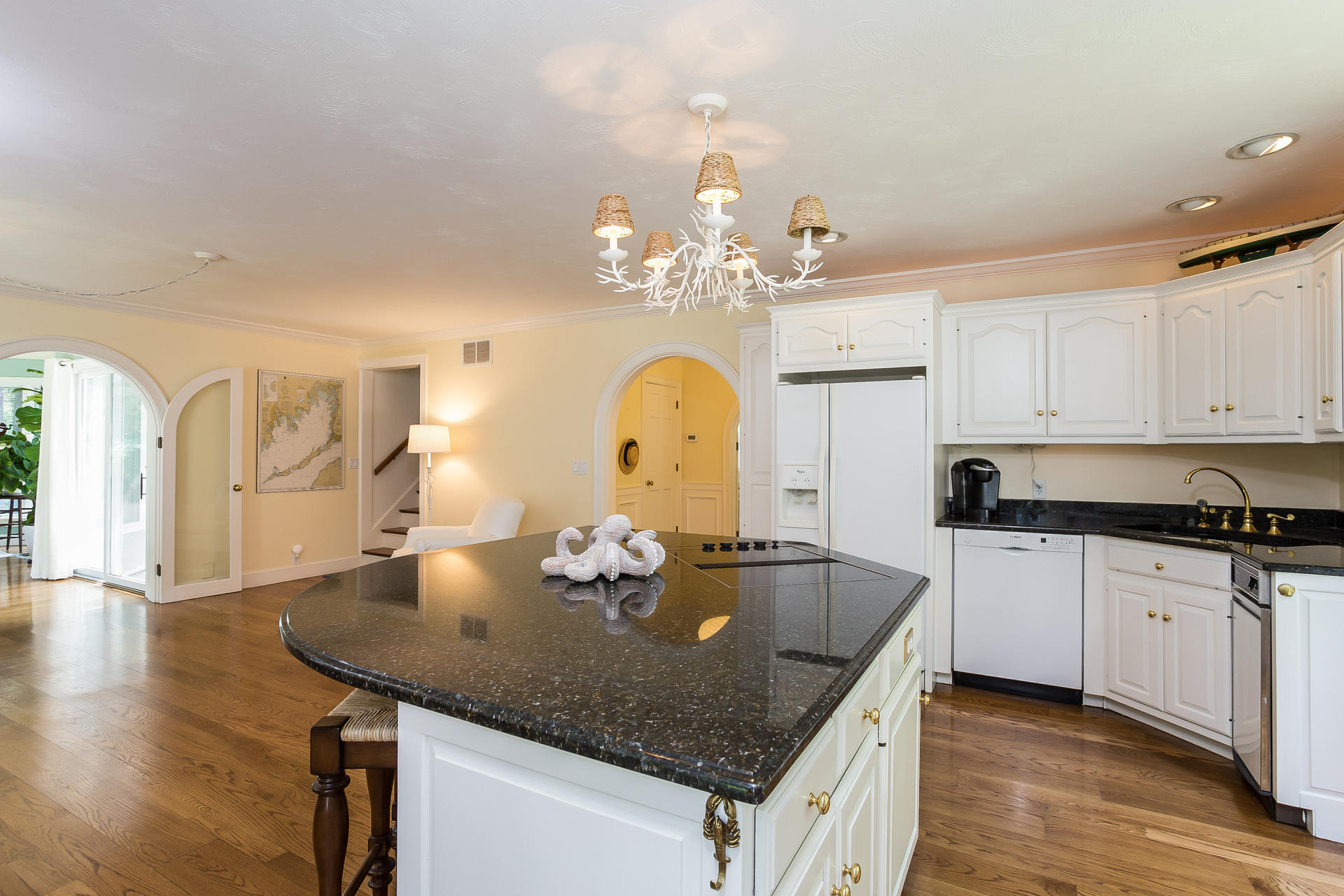 584 Delano Road Marion, MA 02738 - Photo 8 of 24 a kitchen with stainless steel appliances granite countertop a kitchen island a stove a sink a dining table and chairs with wooden floor