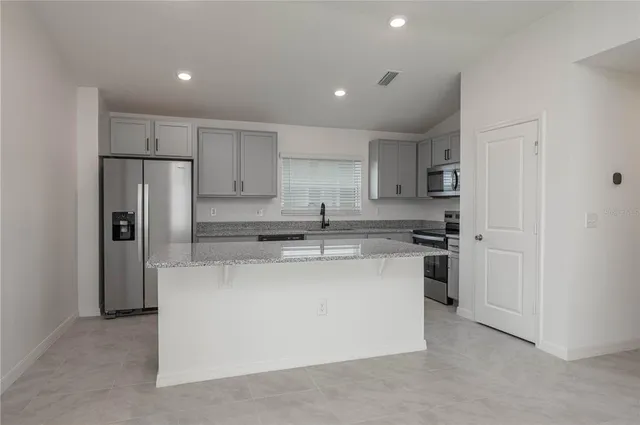a kitchen with stainless steel appliances a refrigerator and a stove