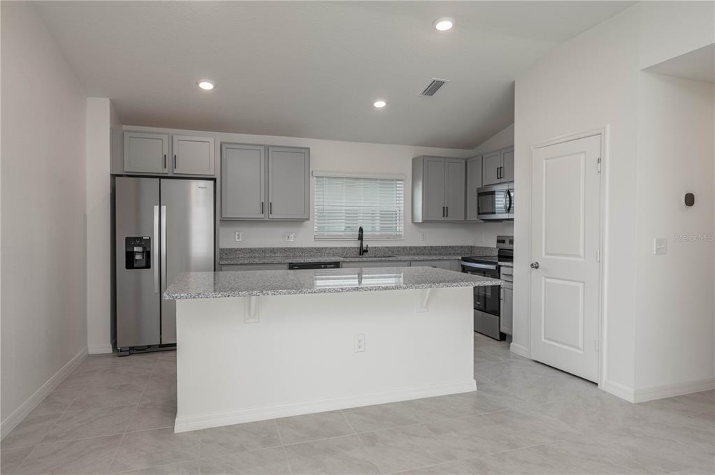 622 Meadows Edge Place Lake Wales, FL 33859 - Photo 4 of 9 a kitchen with stainless steel appliances a refrigerator and a stove