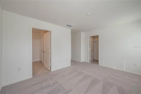 a view of an empty room and closet area