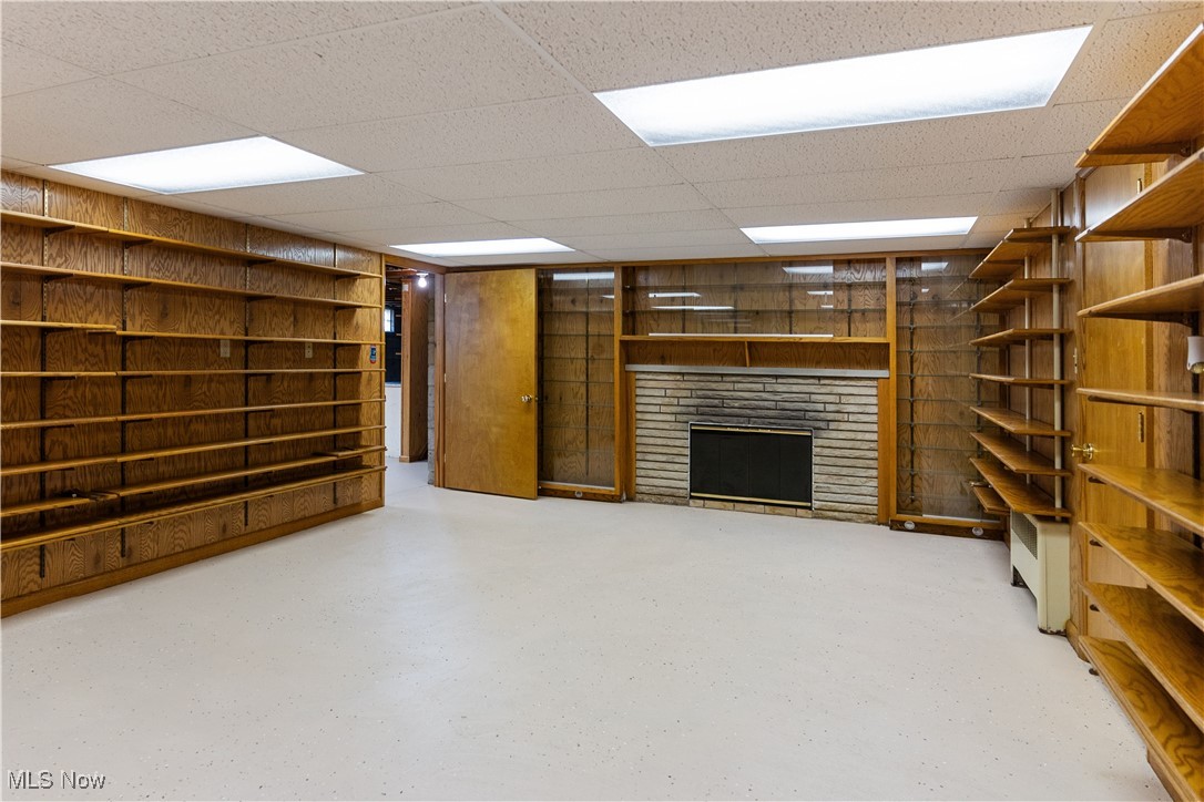 948 Carson Salt Springs Road Warren, OH 44481 - Photo 23 of 31 Basement featuring a paneled ceiling and a brick fireplace