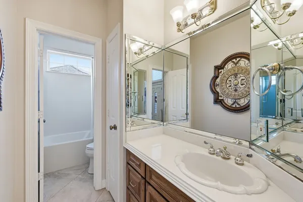 a bathroom with a sink vanity and a mirror