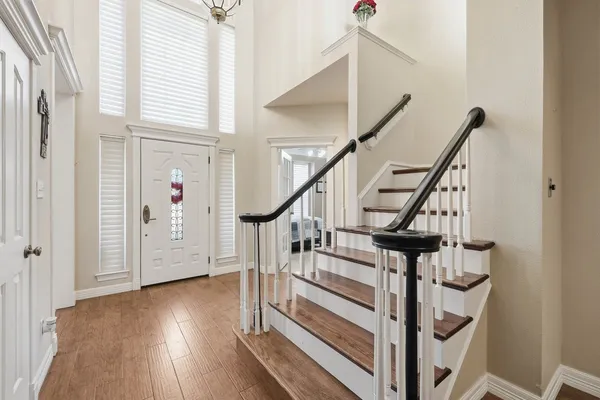 a view of entryway with wooden floor and stairs