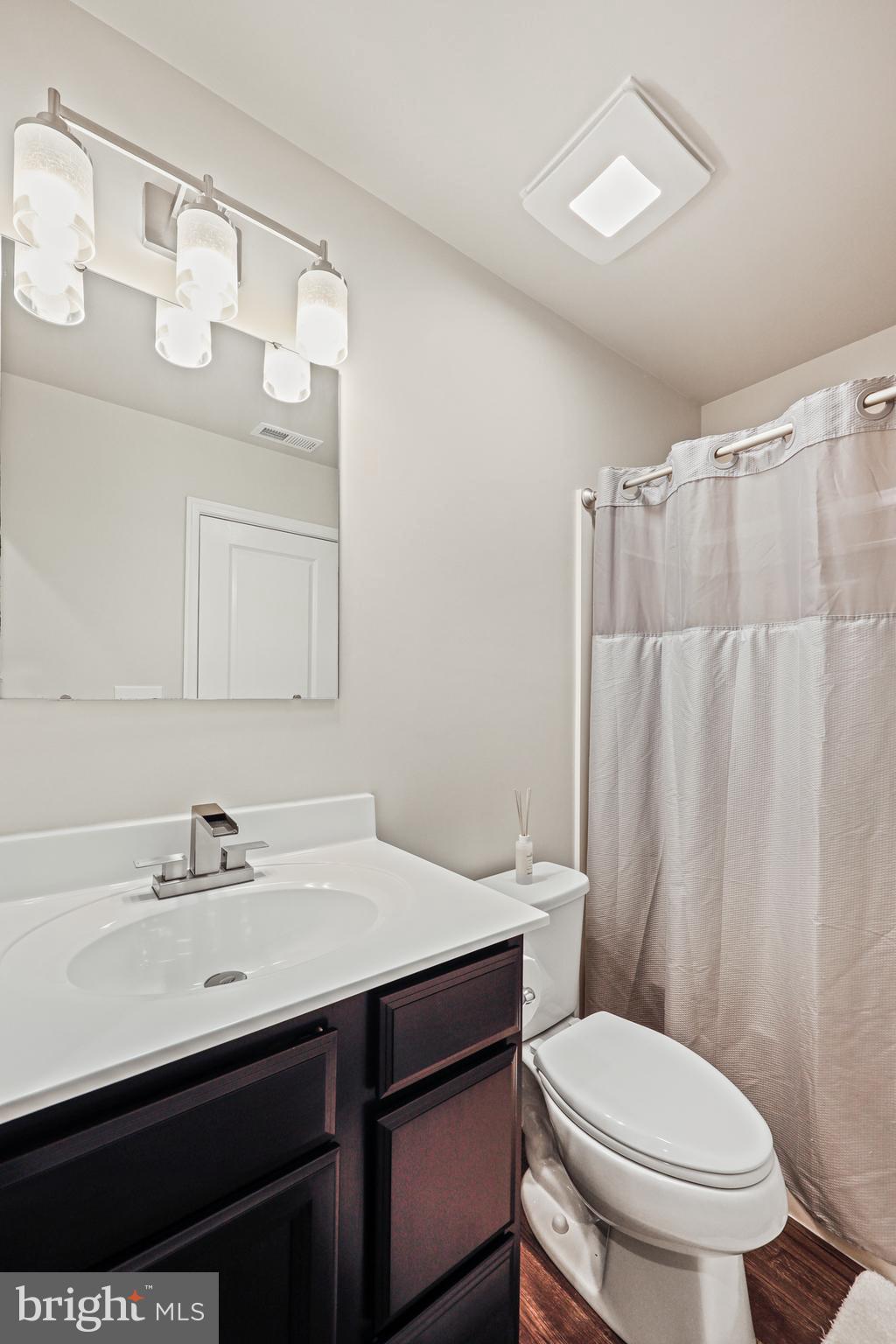 16 Azalea Circle Elkton, MD 21921 - Photo 17 of 30 a bathroom with a sink a toilet a mirror and shower curtain