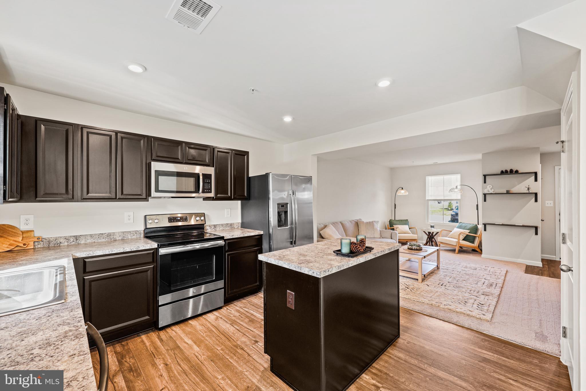 16 Azalea Circle Elkton, MD 21921 - Photo 9 of 30 a kitchen with stainless steel appliances kitchen island granite countertop a stove refrigerator and sink