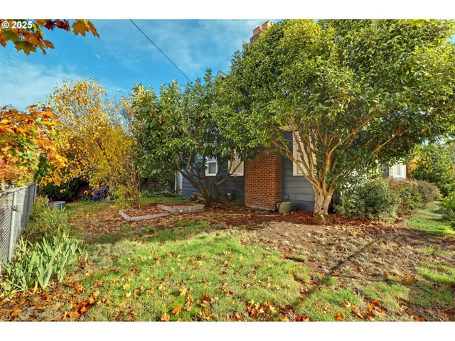 a yellow house with trees in front of it