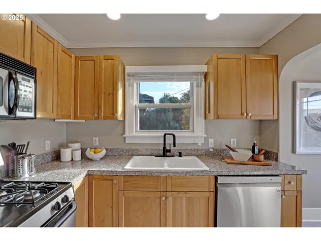 a kitchen with sink a stove and cabinets
