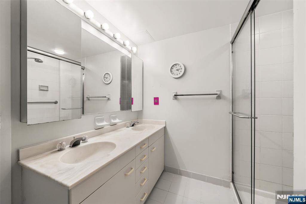 800 Palisade Avenue, Unit 1804 Fort Lee, NJ 07024 - Photo 17 of 23 a bathroom with a sink and mirror