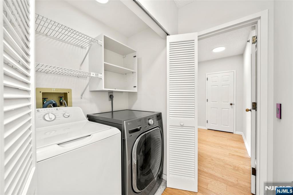 800 Palisade Avenue, Unit 1804 Fort Lee, NJ 07024 - Photo 19 of 23 a view of washer and dryer with bathroom in the background