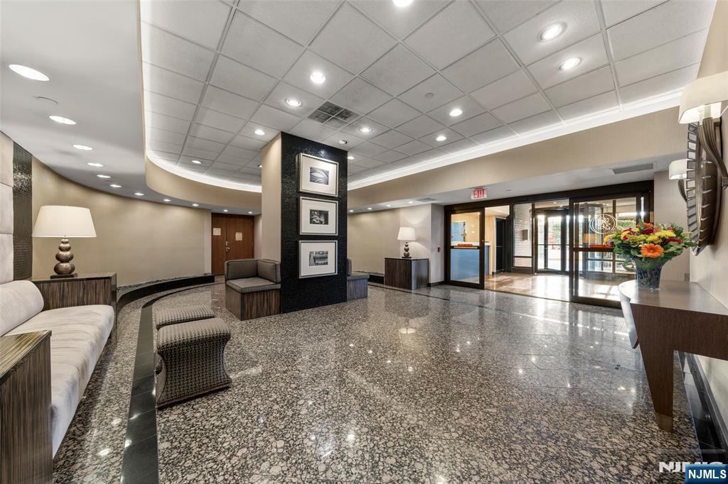 800 Palisade Avenue, Unit 1804 Fort Lee, NJ 07024 - Photo 2 of 23 a lobby with furniture and floor to ceiling window