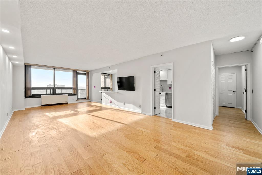 800 Palisade Avenue, Unit 1804 Fort Lee, NJ 07024 - Photo 4 of 23 a view of a livingroom with a flat screen tv