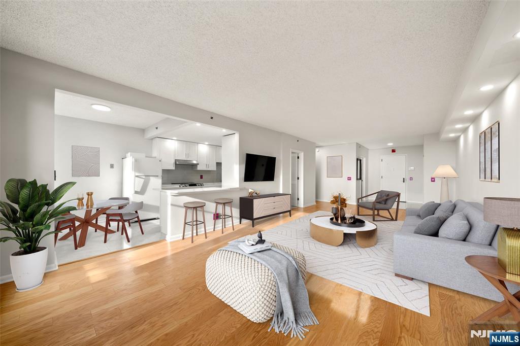 800 Palisade Avenue, Unit 1804 Fort Lee, NJ 07024 - Photo 5 of 23 a living room with furniture and a flat screen tv