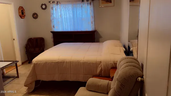a bedroom with bed and a chandelier