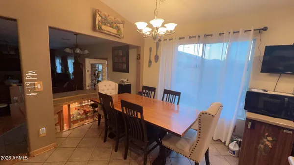 a view of a dining room with furniture and chandelier